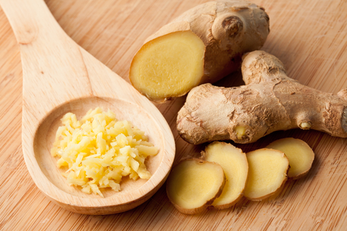 Different forms of ginger against a wood worktop
