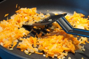 Onions and carrots fried in a skillet